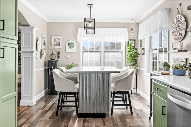 dining area with dark wood-type flooring, ornate columns, baseboards, and ornamental molding