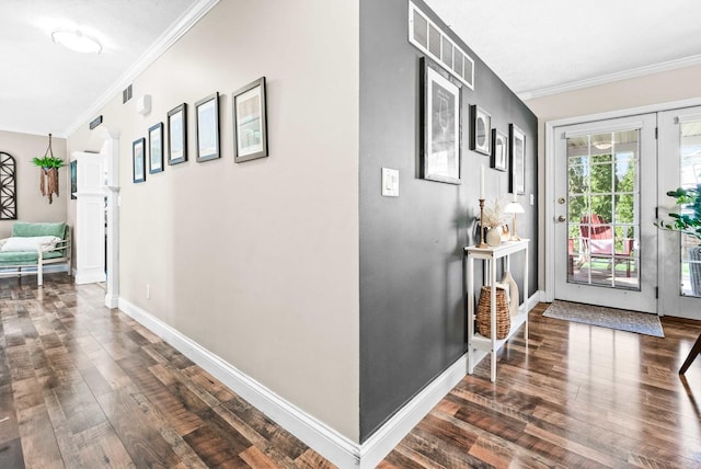 hallway featuring wood finished floors, baseboards, and ornamental molding
