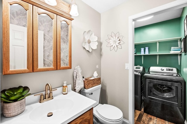 bathroom featuring separate washer and dryer, vanity, and toilet