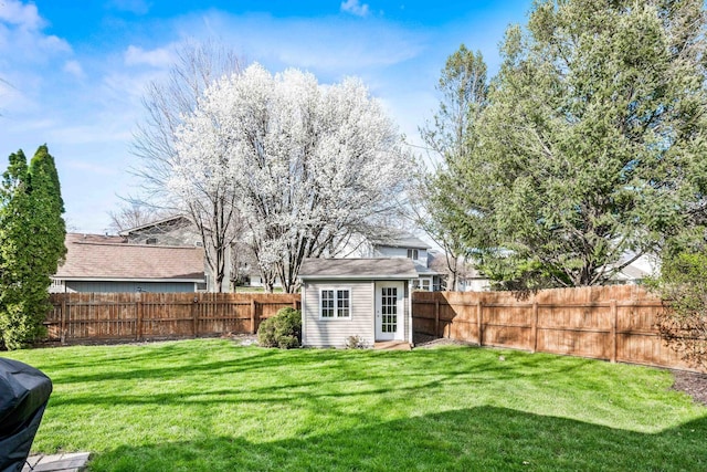 view of yard with an outdoor structure and a fenced backyard