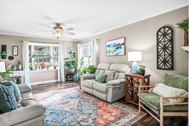 living area with baseboards, wood finished floors, ceiling fan, and crown molding