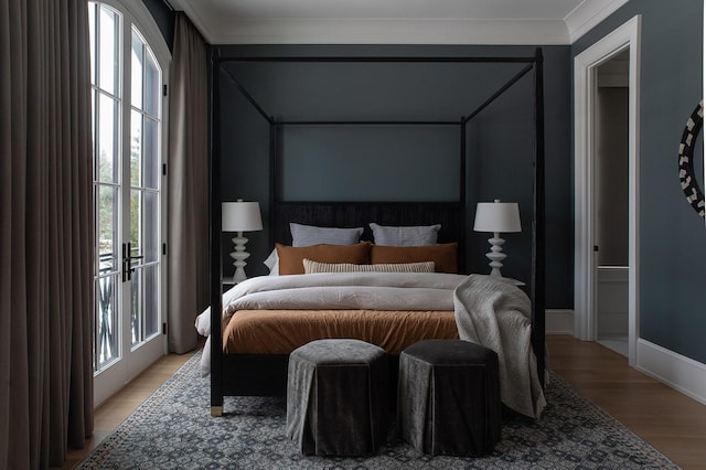 bedroom featuring ornamental molding, baseboards, access to outside, and light wood finished floors