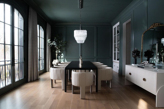 dining space featuring a chandelier, a decorative wall, and a wealth of natural light
