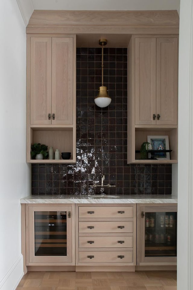 bar featuring wine cooler, backsplash, and a dry bar