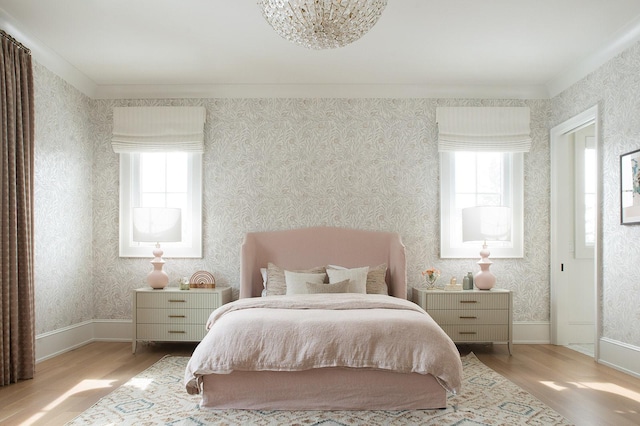 bedroom with multiple windows and light wood-style floors