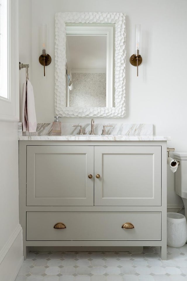 bathroom with toilet, tile patterned floors, and vanity