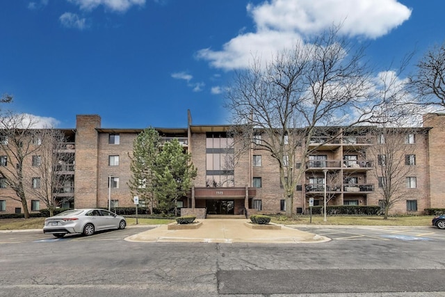 view of building exterior with uncovered parking