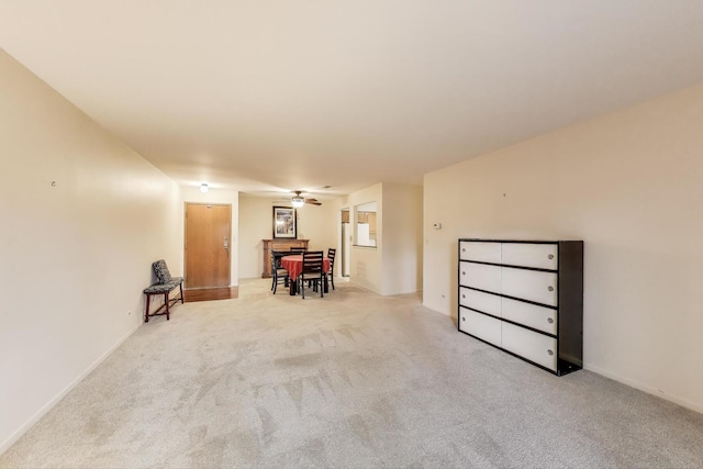 unfurnished room featuring ceiling fan and carpet