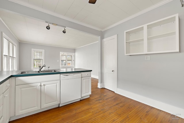 kitchen featuring hardwood / wood-style floors, rail lighting, white cabinets, dishwasher, and a sink