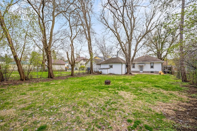 view of yard with a fire pit and a fenced backyard