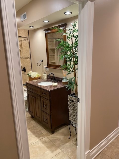 bathroom with tiled shower, visible vents, tile patterned flooring, vanity, and recessed lighting