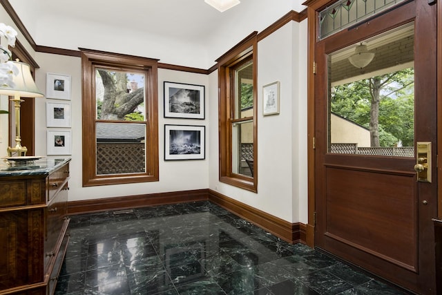doorway to outside featuring marble finish floor and baseboards