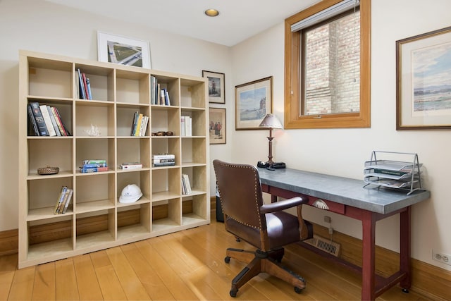 home office with wood finished floors