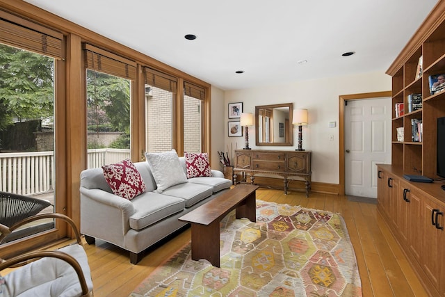 living room featuring recessed lighting, light wood-type flooring, and baseboards
