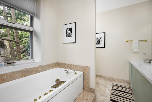 bathroom with a jetted tub and vanity