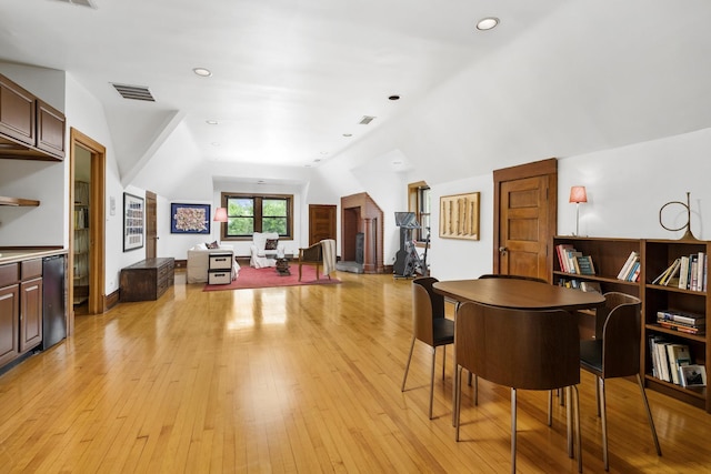 dining area with recessed lighting, lofted ceiling, visible vents, and light wood-style flooring