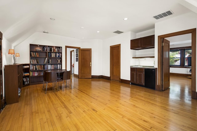 kitchen with light wood-style flooring, baseboards, and visible vents