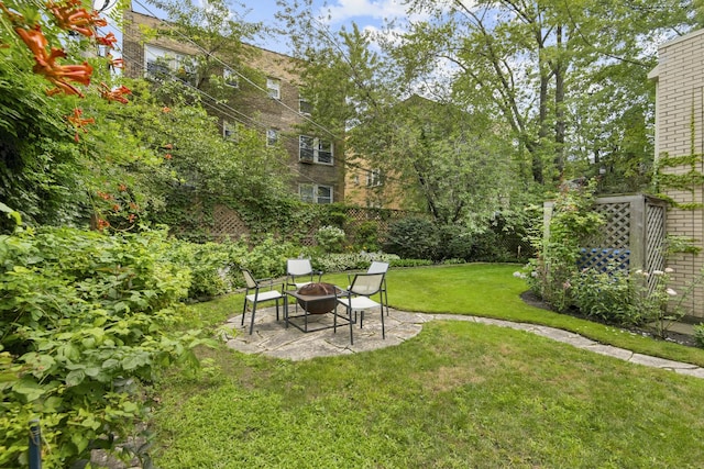 view of yard featuring a patio area and an outdoor fire pit