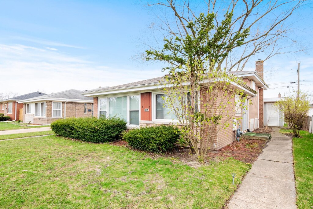 1358 Mackinaw Ave, Calumet City, IL 60409 - view of front of house with a chimney, a front yard, and brick siding