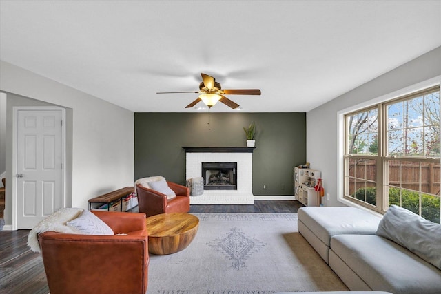 3410 Waterville Ct, Champaign, IL 61822 - living area featuring baseboards, dark wood-style floors, a fireplace, and ceiling fan