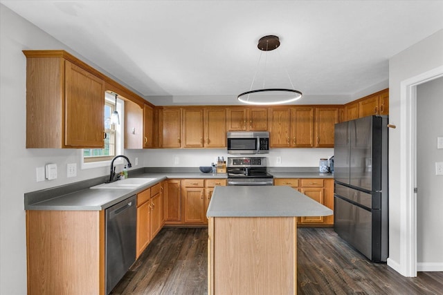 3410 Waterville Ct, Champaign, IL 61822 - kitchen featuring brown cabinets, dark wood finished floors, stainless steel appliances, a sink, and a kitchen island