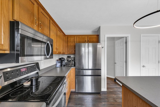 3410 Waterville Ct, Champaign, IL 61822 - kitchen featuring dark countertops, brown cabinets, appliances with stainless steel finishes, and dark wood finished floors