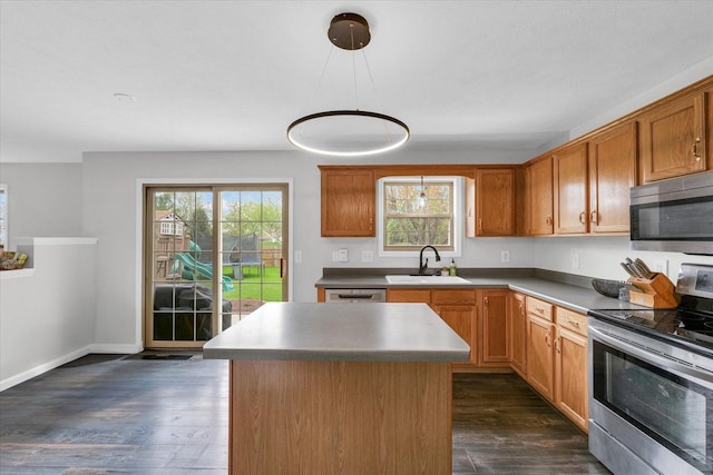 3410 Waterville Ct, Champaign, IL 61822 - kitchen with dark wood-type flooring, appliances with stainless steel finishes, a center island, and a sink