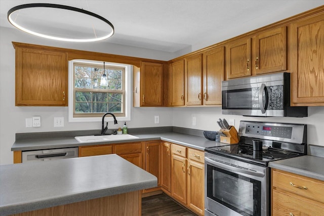 3410 Waterville Ct, Champaign, IL 61822 - kitchen featuring brown cabinets, appliances with stainless steel finishes, dark wood-style flooring, and a sink