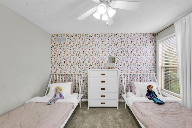 3410 Waterville Ct, Champaign, IL 61822 - carpeted bedroom featuring wallpapered walls, visible vents, an accent wall, and ceiling fan
