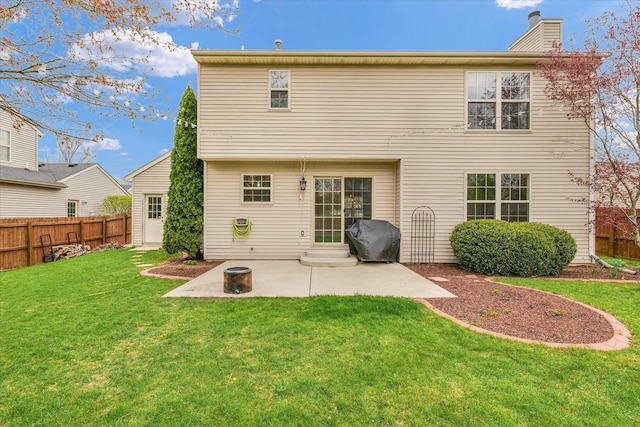 3410 Waterville Ct, Champaign, IL 61822 - back of house featuring a lawn, fence, a chimney, and a patio