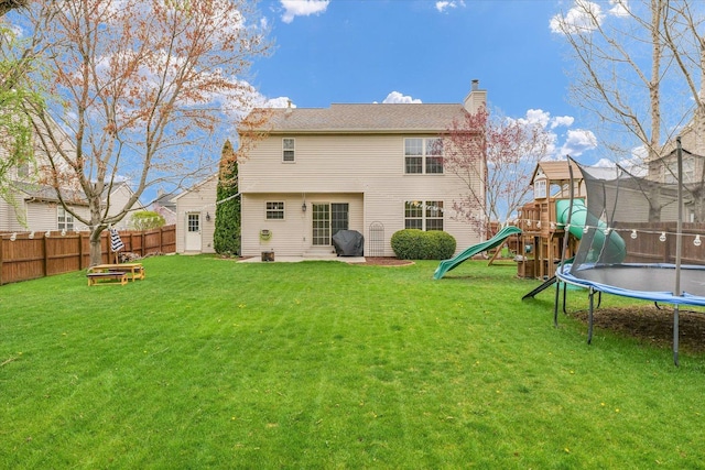 3410 Waterville Ct, Champaign, IL 61822 - back of property featuring a fenced backyard, a chimney, a playground, a trampoline, and a yard