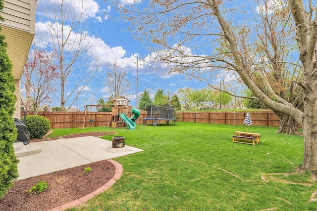 3410 Waterville Ct, Champaign, IL 61822 - view of yard featuring a trampoline, a fenced backyard, a patio, and a playground