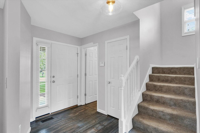 3410 Waterville Ct, Champaign, IL 61822 - entrance foyer with stairway, baseboards, visible vents, and dark wood-style floors