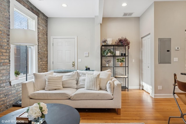 1019 N Washtenaw Ave Unit 2, Chicago, IL 60622 - living room with electric panel, light wood-type flooring, baseboards, brick wall, and recessed lighting