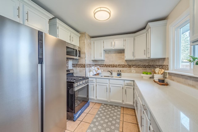 16112 Turner Ave, Markham, IL 60428 - kitchen featuring tasteful backsplash, light tile patterned floors, a sink, light countertops, and appliances with stainless steel finishes