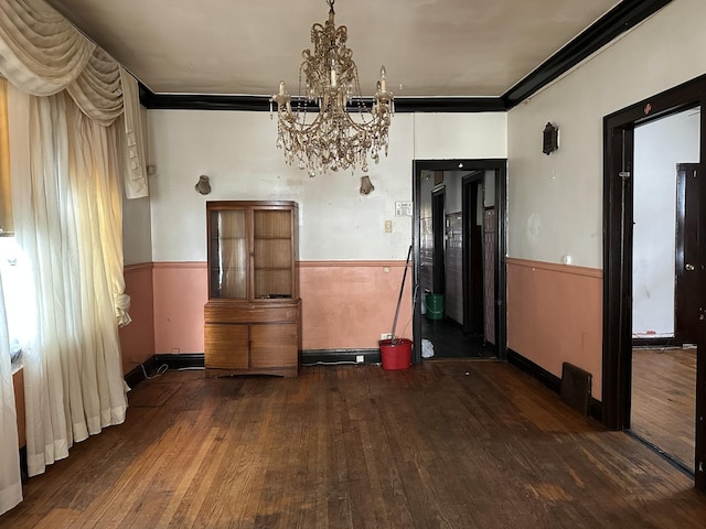 8444 S Essex Ave, Chicago, IL 60617 - unfurnished dining area featuring crown molding, an inviting chandelier, and hardwood / wood-style flooring