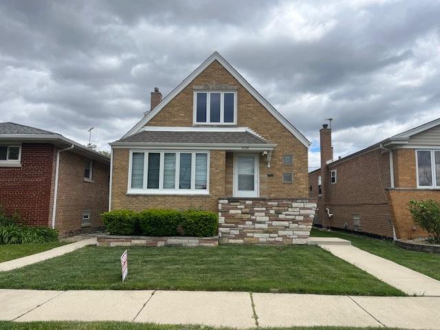 5705 S Mayfield Ave, Chicago, IL 60638 - view of front of property featuring a chimney, a front lawn, and brick siding