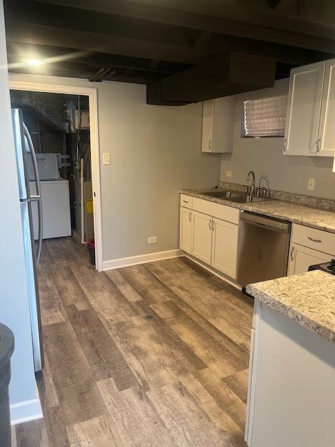 5705 S Mayfield Ave, Chicago, IL 60638 - kitchen featuring dishwasher, freestanding refrigerator, a sink, washer / clothes dryer, and white cabinetry