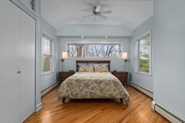 bedroom with vaulted ceiling and a baseboard radiator