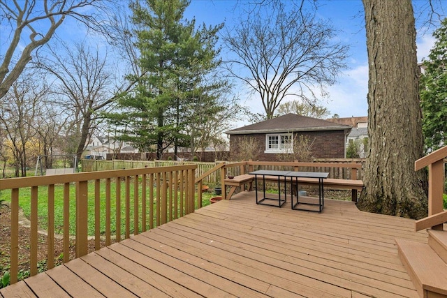 deck with a lawn and fence