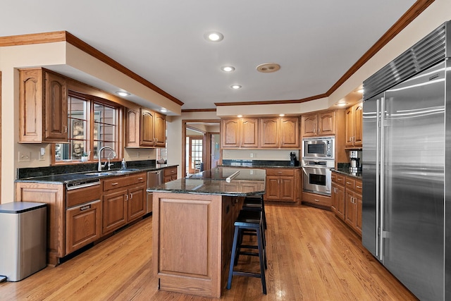4001 Wyndwood Dr, Crystal Lake, IL 60014 - kitchen featuring built in appliances, light wood-style flooring, a sink, and crown molding