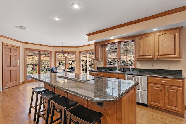 4001 Wyndwood Dr, Crystal Lake, IL 60014 - kitchen with dishwasher, a sink, a breakfast bar, a chandelier, and a kitchen island