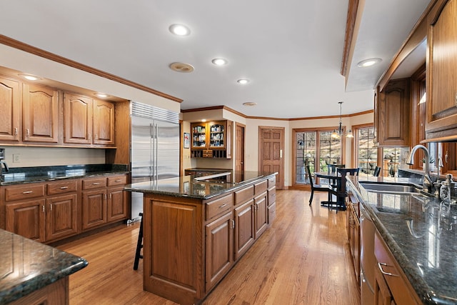 4001 Wyndwood Dr, Crystal Lake, IL 60014 - kitchen featuring a center island, a sink, light wood-type flooring, brown cabinets, and stainless steel appliances