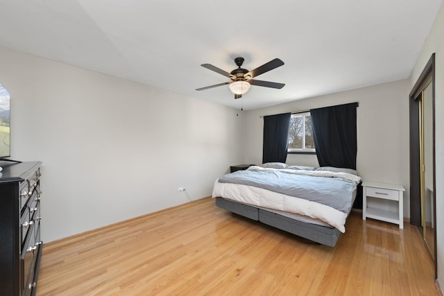 bedroom featuring light wood finished floors and ceiling fan