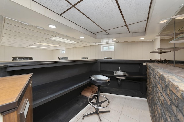 bar with a sink, tile patterned floors, recessed lighting, and a drop ceiling