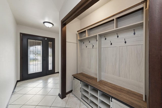 mudroom with light tile patterned floors and baseboards