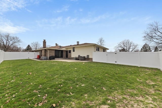 view of yard featuring a fenced backyard, a patio area, and a gate