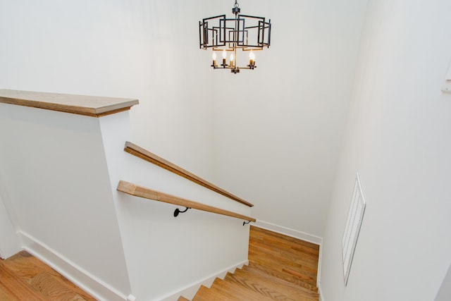 3621 N Richmond St, Chicago, IL 60618 - stairs featuring baseboards, an inviting chandelier, and wood finished floors
