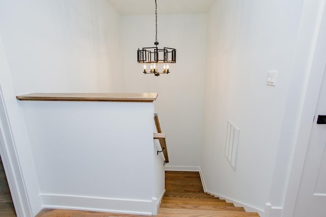 3621 N Richmond St, Chicago, IL 60618 - stairs featuring visible vents, baseboards, an inviting chandelier, and wood finished floors