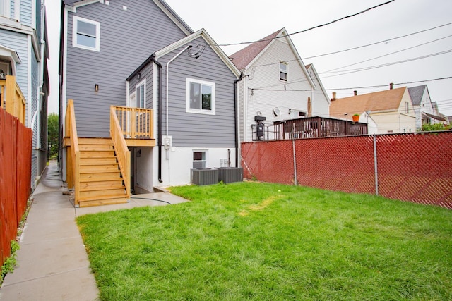 3621 N Richmond St, Chicago, IL 60618 - back of property with a yard, fence, central air condition unit, a wooden deck, and stairs